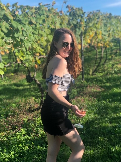 Photo of Kayla in a vineyard